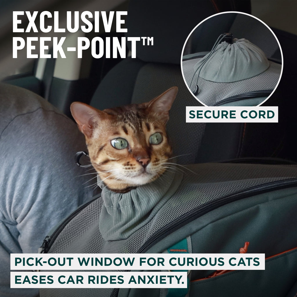 A cat wearing a gray pet car seat cover inside a car, with text overlays describing the 'Exclusive Peek-Point' secure cord and pick-out window benefits.
